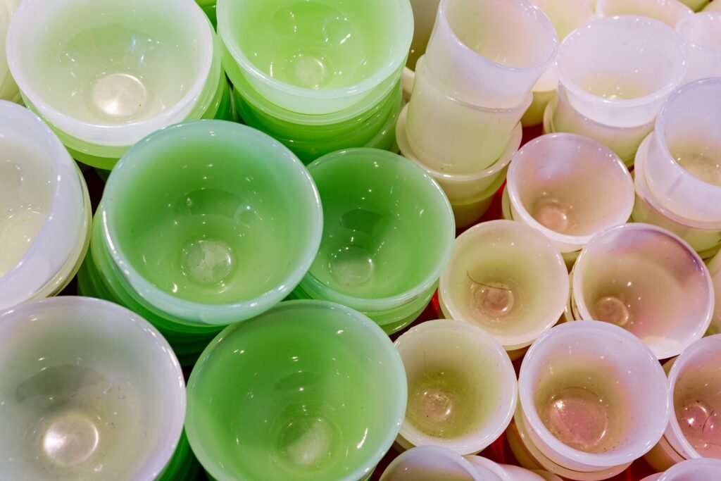 A close up of many different colored cups